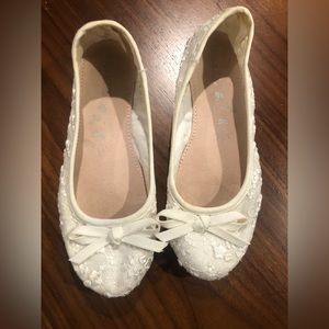 Girls’ white flats